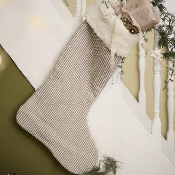 Christmas stockings hanging on a staircase with decorative elements.